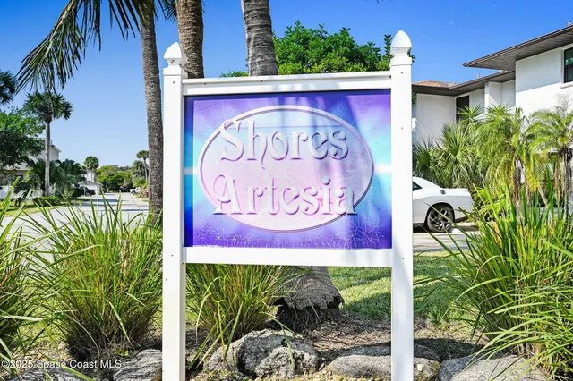 a dining room with furniture and a floor to ceiling window