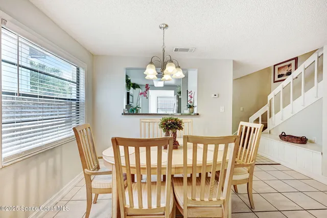 a kitchen with granite countertop a sink a stove and cabinets