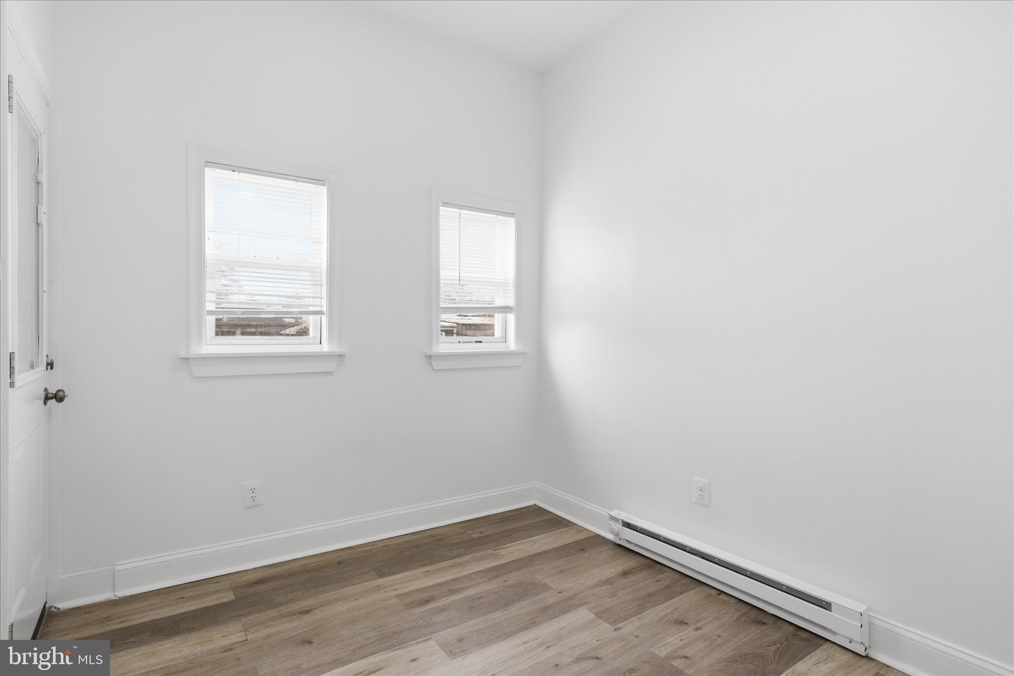 221 20th Street Northeast, Unit 4 Washington, DC 20002 - Photo 23 of 30 an empty room with wooden floor and windows