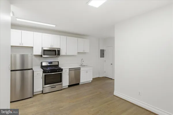 a kitchen with a refrigerator stove and microwave