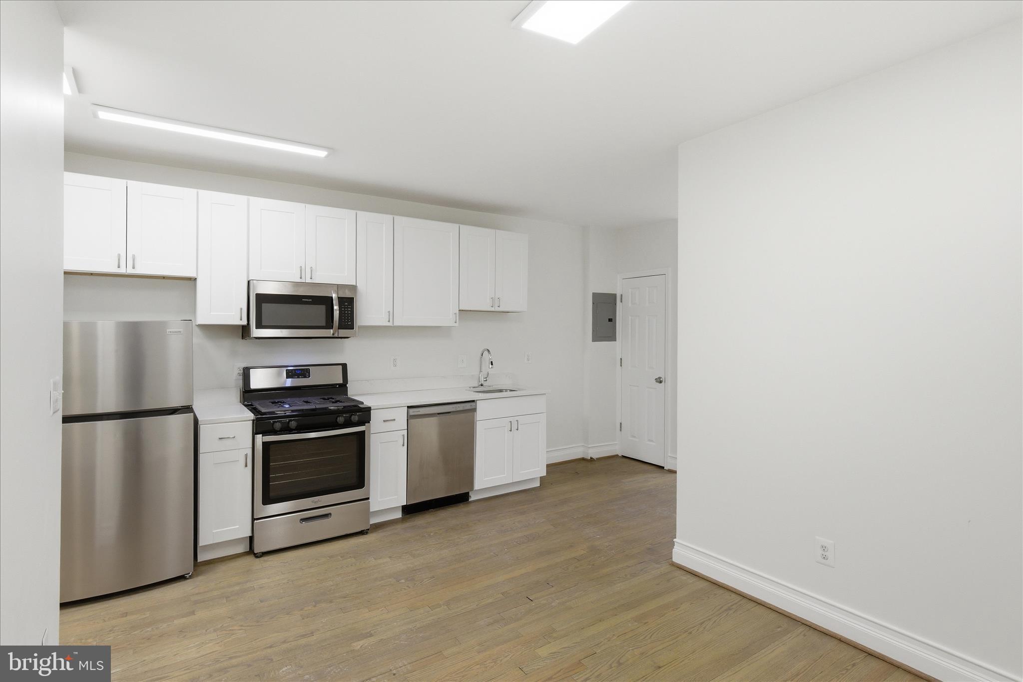 221 20th Street Northeast, Unit 4 Washington, DC 20002 - Photo 8 of 30 a kitchen with a refrigerator stove and microwave