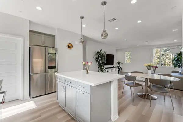 a kitchen with a sink a counter top stainless steel appliances and cabinets