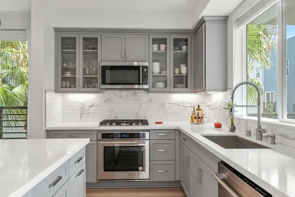 a kitchen with stainless steel appliances a stove sink and microwave