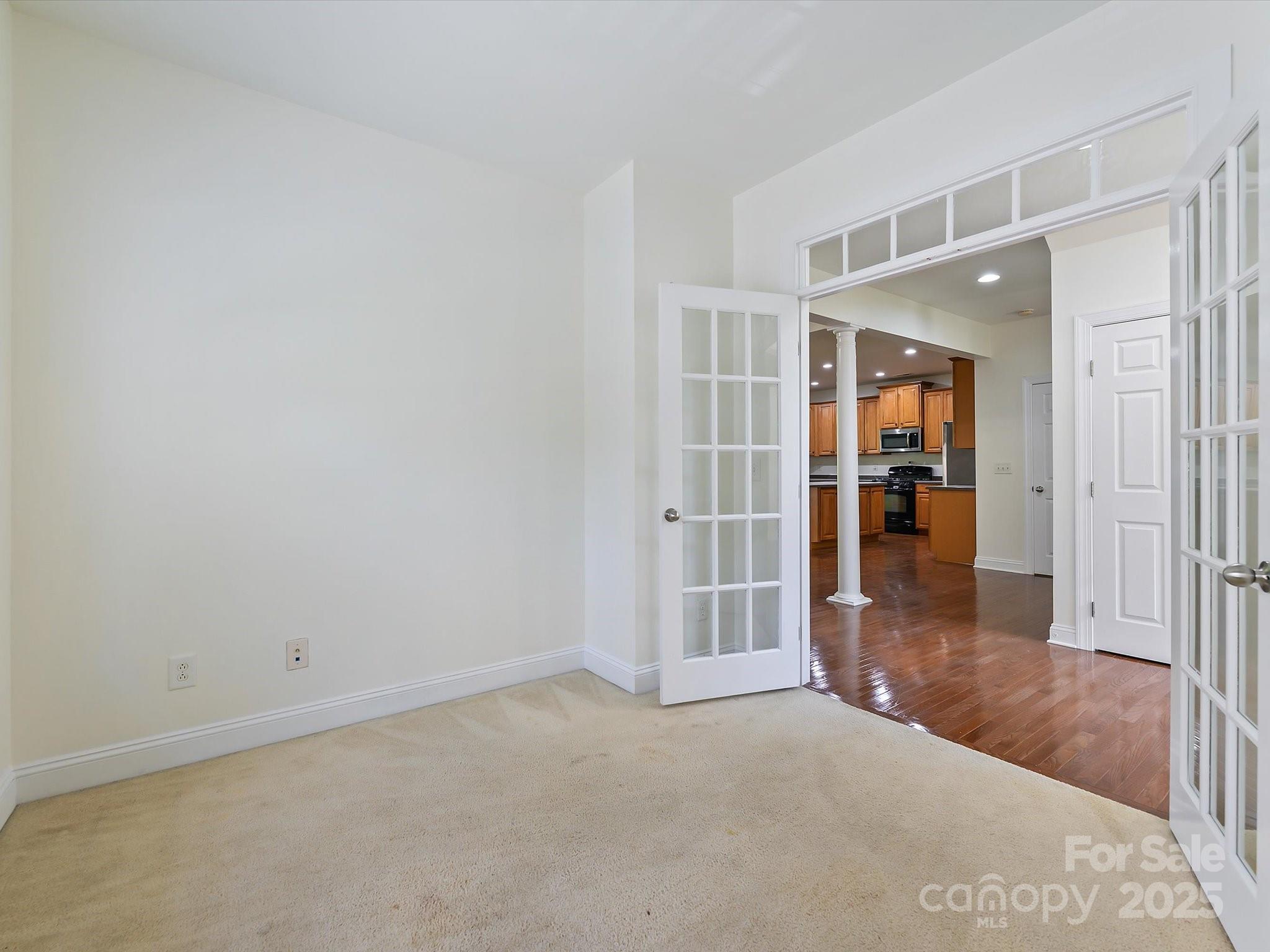 524 Becker Avenue Fort Mill, SC 29715 - Photo 13 of 39 an empty room with wooden floor and a bathroom