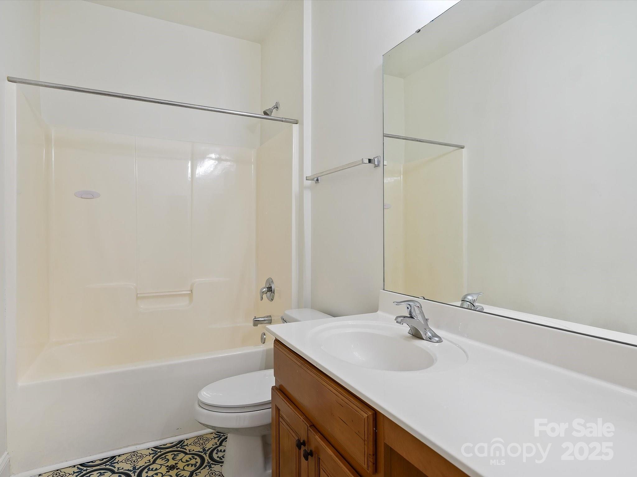524 Becker Avenue Fort Mill, SC 29715 - Photo 31 of 39 a bathroom with a sink a toilet and a large mirror