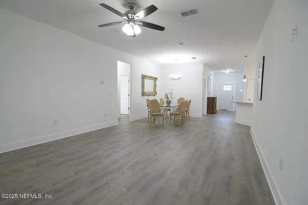 a view of dining room with furniture and a chandelier