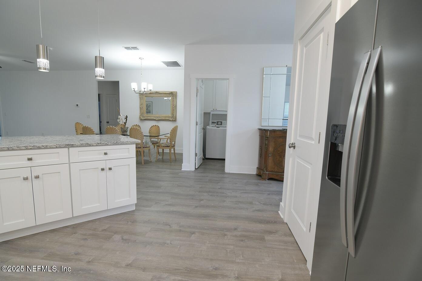 961 Calypso Way, Unit LOT 20 Jacksonville, FL 32233 - Photo 17 of 35 a view of a kitchen with cabinets and wooden floor