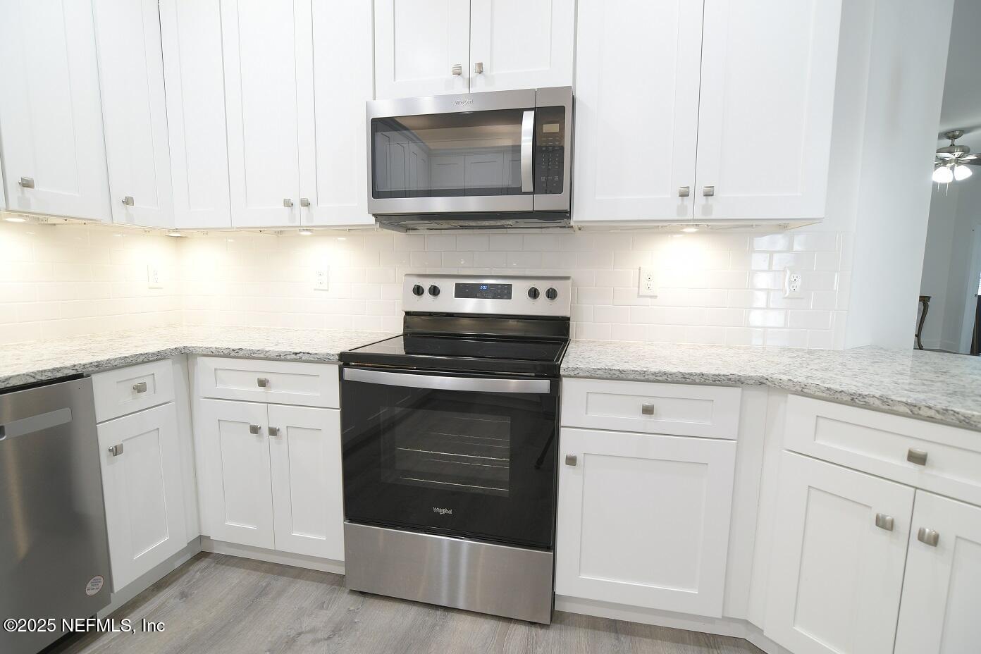 961 Calypso Way, Unit LOT 20 Jacksonville, FL 32233 - Photo 18 of 35 a kitchen with white cabinets and white appliances