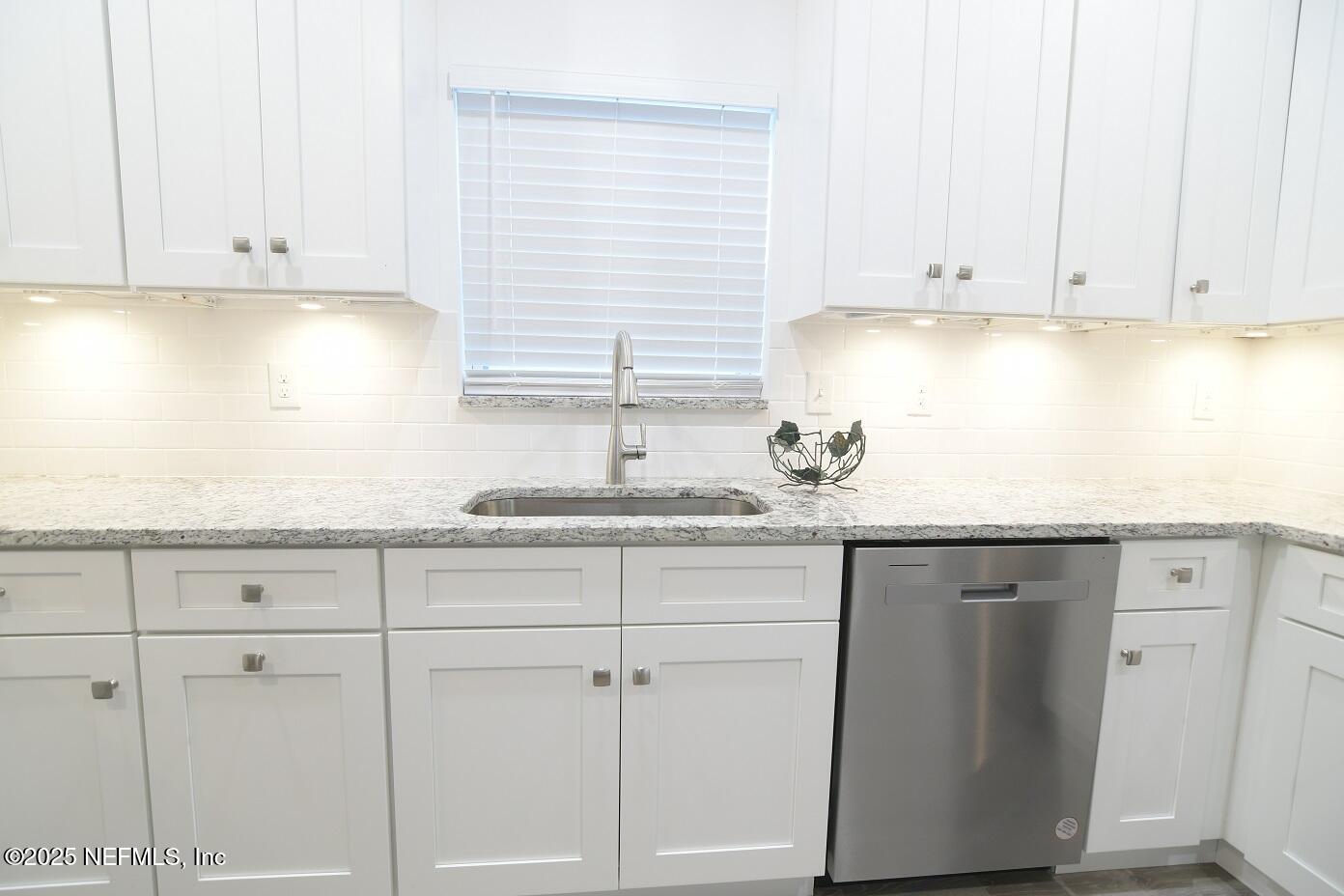 961 Calypso Way, Unit LOT 20 Jacksonville, FL 32233 - Photo 19 of 35 a kitchen with granite countertop white cabinets and a sink