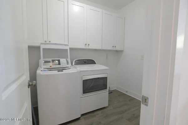 a utility room with sink dryer and washer