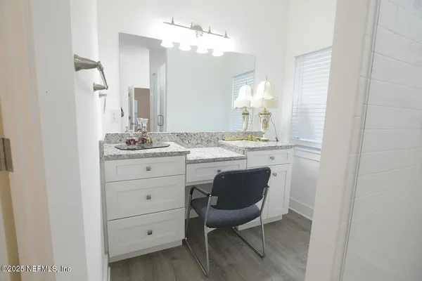 a bathroom with a sink vanity and a mirror