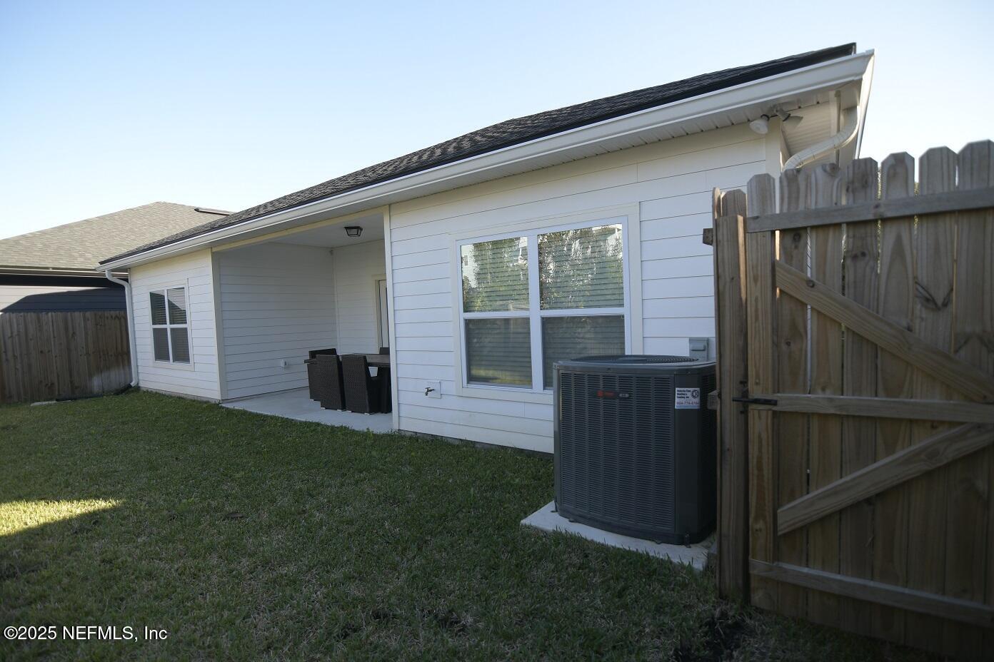 961 Calypso Way, Unit LOT 20 Jacksonville, FL 32233 - Photo 3 of 35 a view of backyard with barbeque grill and wooden fence