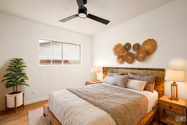 a bedroom with a bed and a potted plant