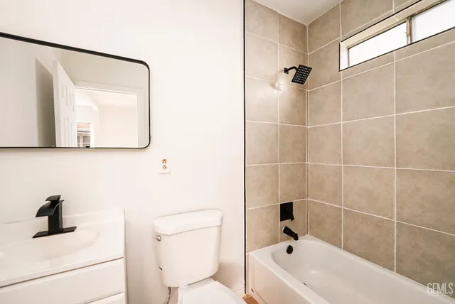 a bathroom with a bathtub sink and toilet