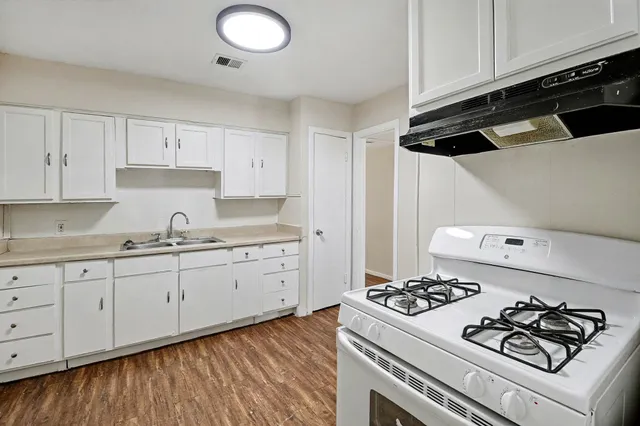 a kitchen with granite countertop cabinets and black appliances