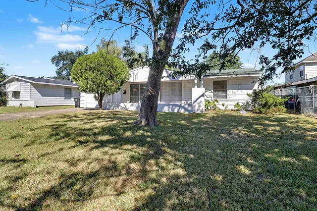 a house view with a tree in front of it