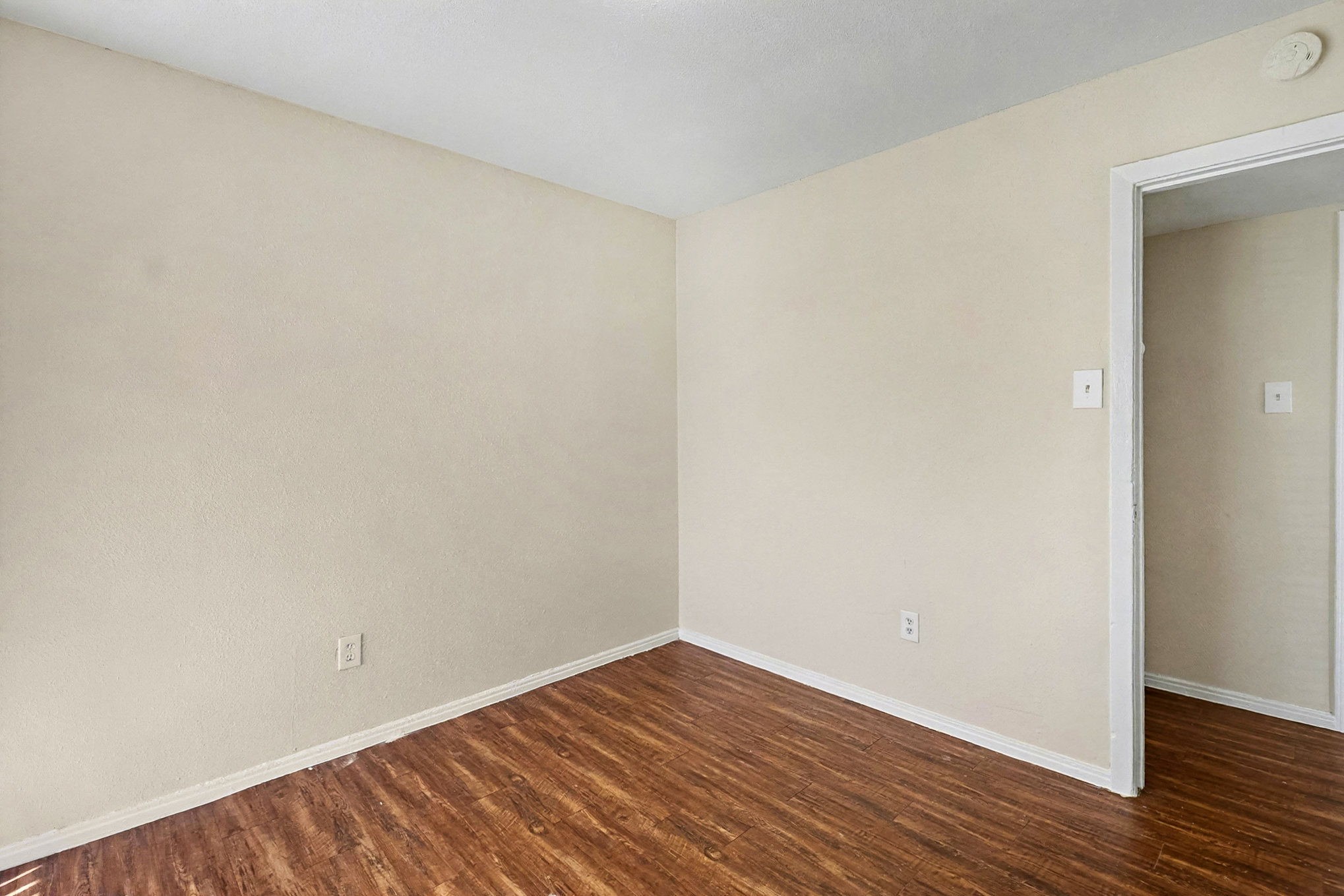 5711 Ridgeway Drive Houston, TX 77033 - Photo 23 of 29 a view of an empty room with wooden floor