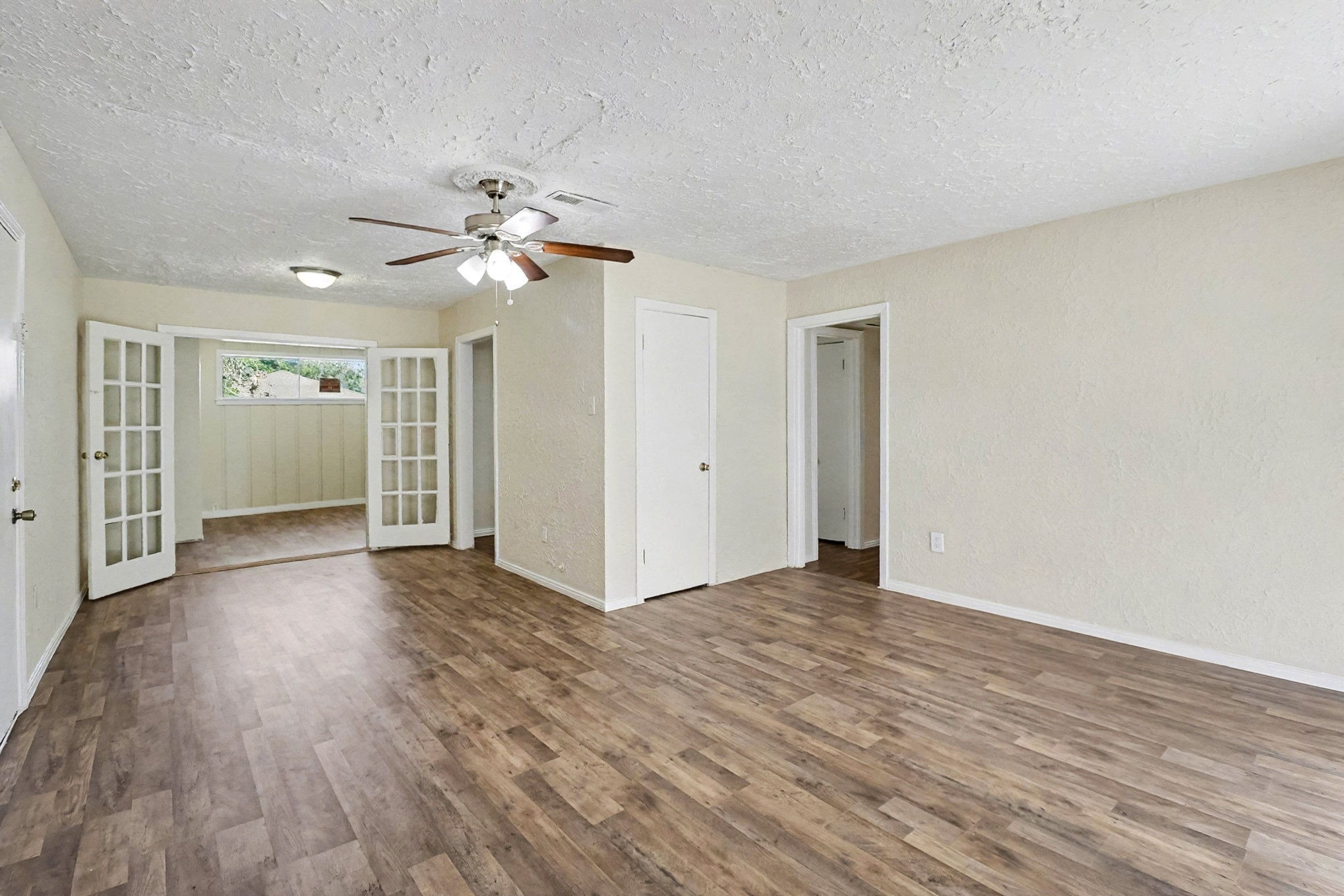 5711 Ridgeway Drive Houston, TX 77033 - Photo 7 of 29 a view of an empty room with wooden floor