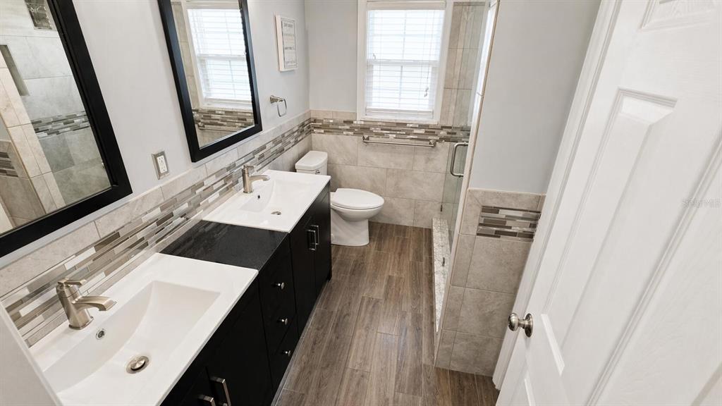 2313 Southeast 7th Street Ocala, FL 34471 - Photo 39 of 54 a bathroom with a sink a toilet and a mirror