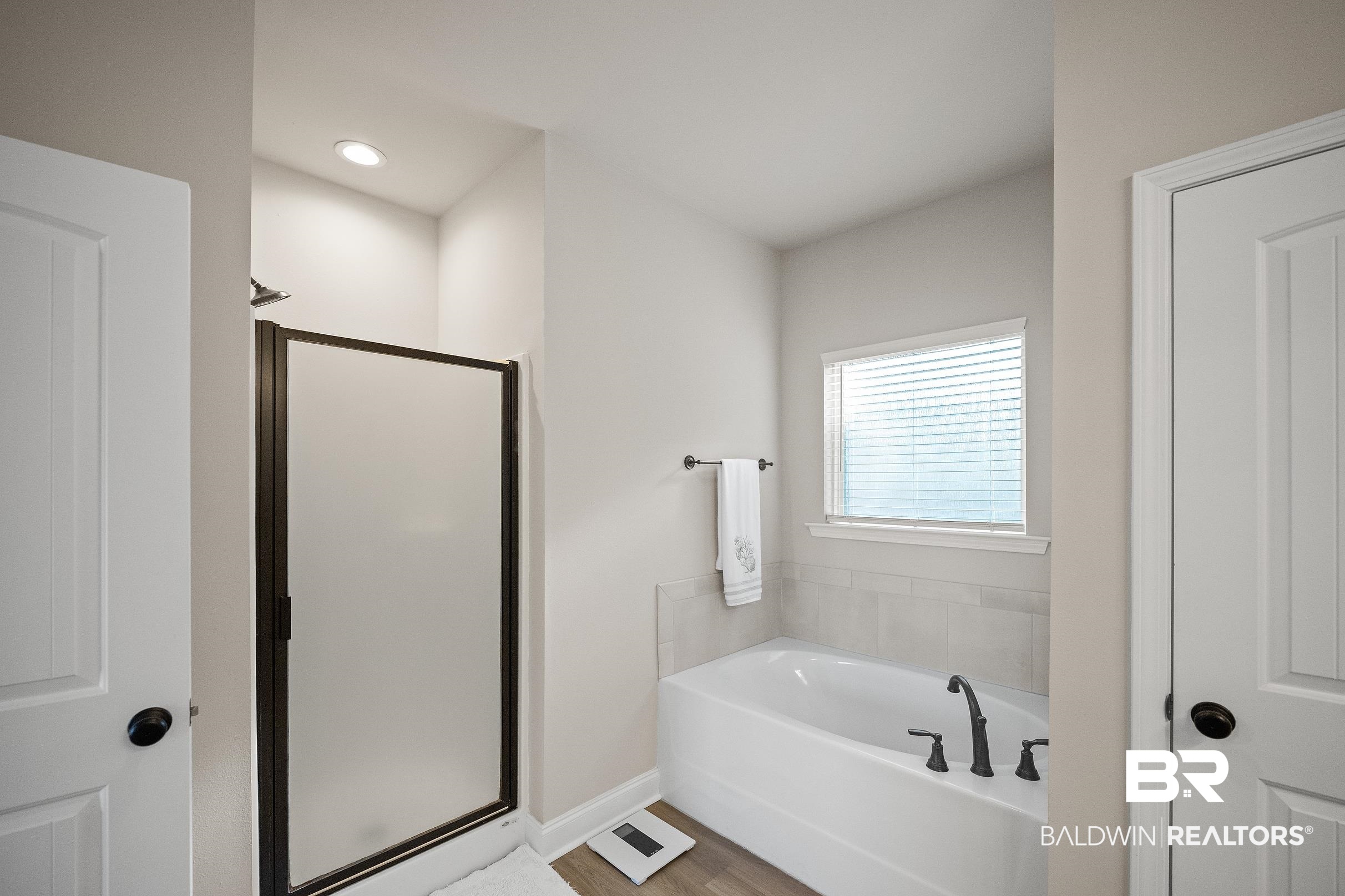 1077 Stella Road Foley, AL 36535 - Photo 22 of 27 Bathroom featuring a shower stall, a bath, wood finished floors, and recessed lighting
