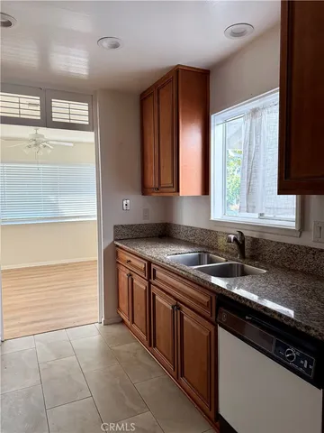a kitchen with stainless steel appliances granite countertop a refrigerator and a stove