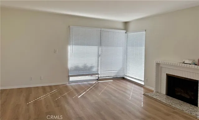 a living room with a fireplace and a rug