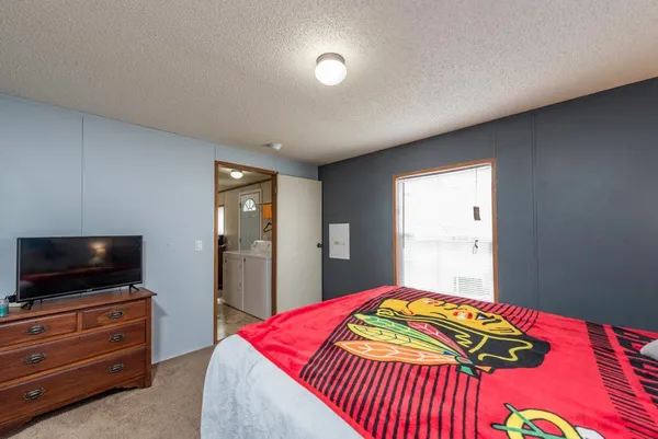 a bedroom with a bed and a flat screen tv