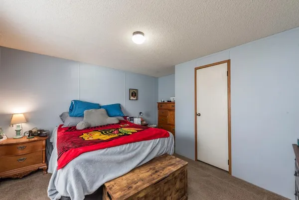 a bedroom with a bed and a closet