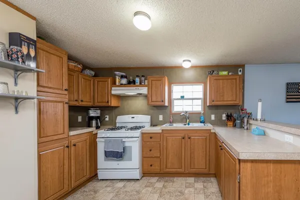 a kitchen with a sink stove and cabinets