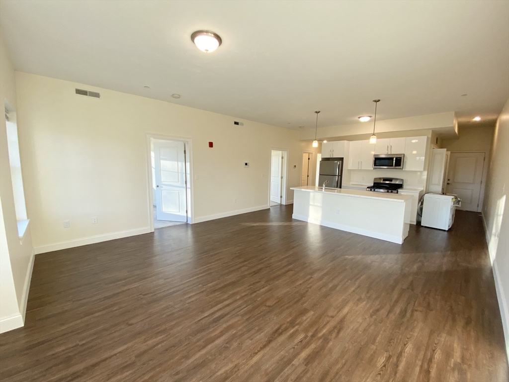 81 Amory Street, Unit 204 Boston, MA 02119 - Photo 1 of 12 a view of a kitchen with a sink and a refrigerator