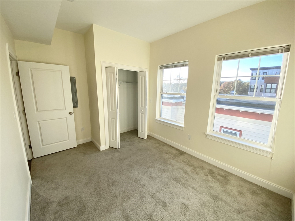81 Amory Street, Unit 204 Boston, MA 02119 - Photo 11 of 12 an empty room with windows