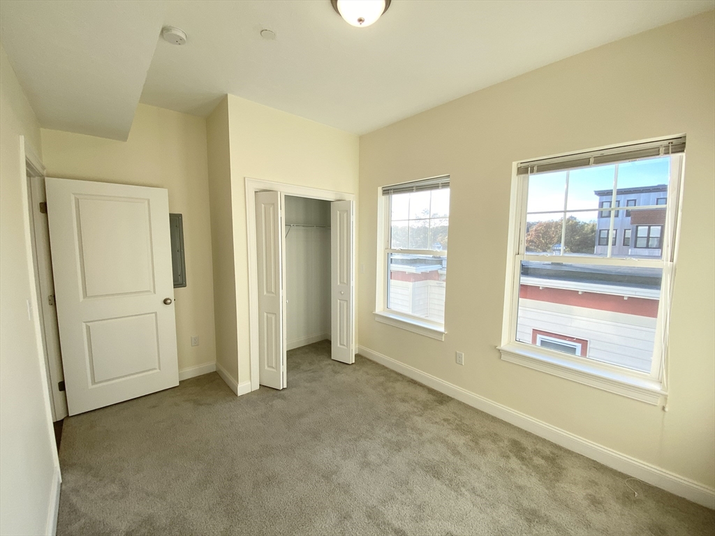 81 Amory Street, Unit 204 Boston, MA 02119 - Photo 12 of 12 a view of an empty room with a window
