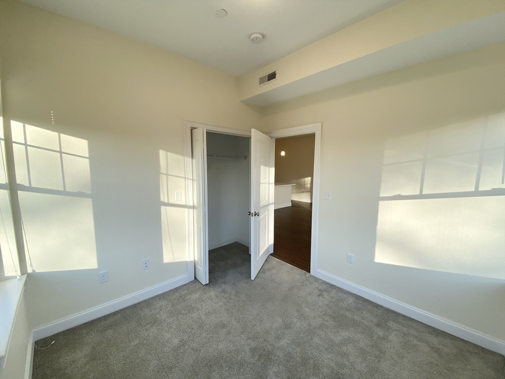 81 Amory Street, Unit 204 Boston, MA 02119 - Photo 6 of 12 a view of empty room with window