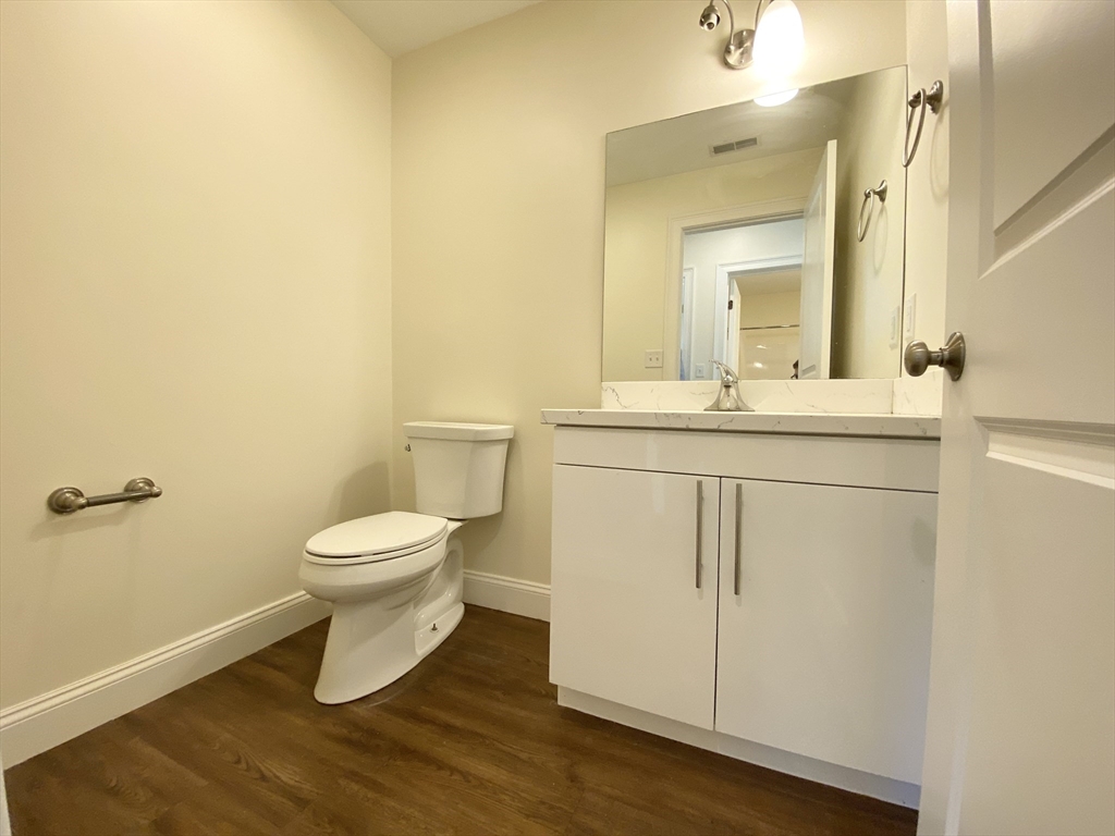 81 Amory Street, Unit 204 Boston, MA 02119 - Photo 8 of 12 a bathroom with a sink a toilet and a mirror