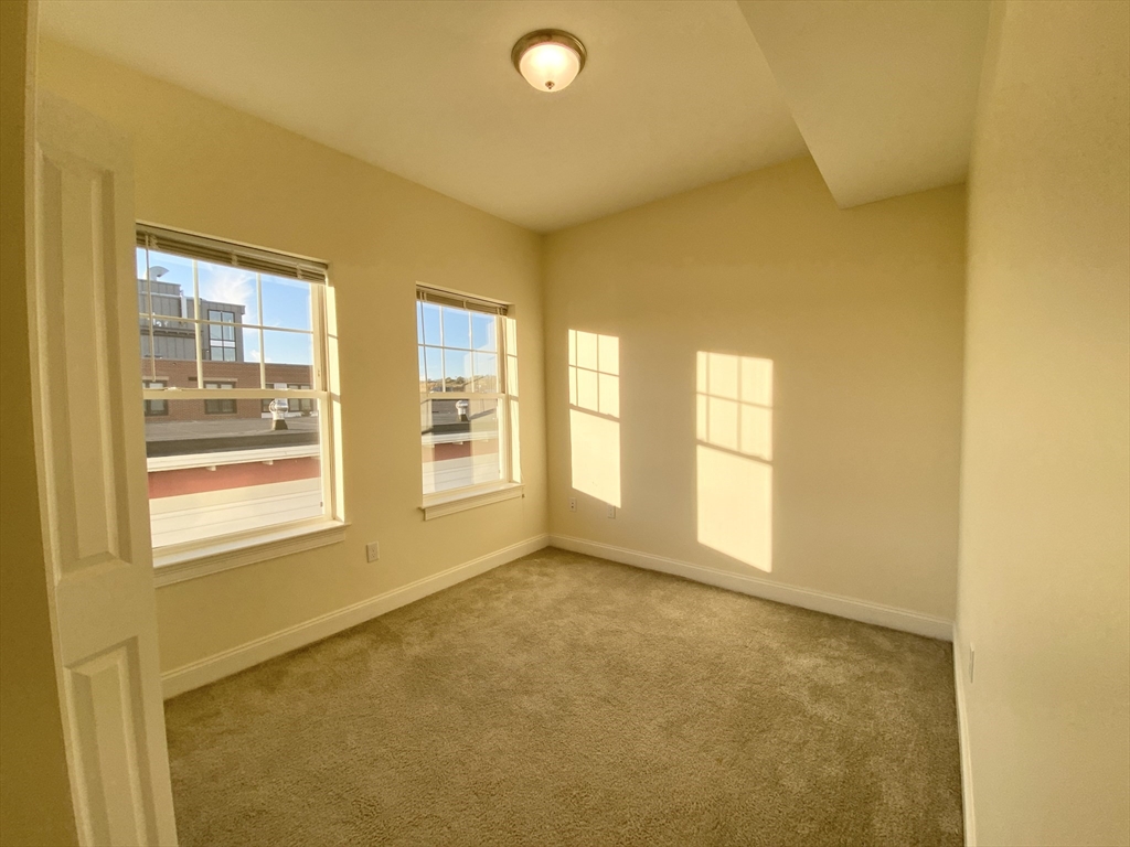 81 Amory Street, Unit 204 Boston, MA 02119 - Photo 10 of 12 a view of an empty room with a window