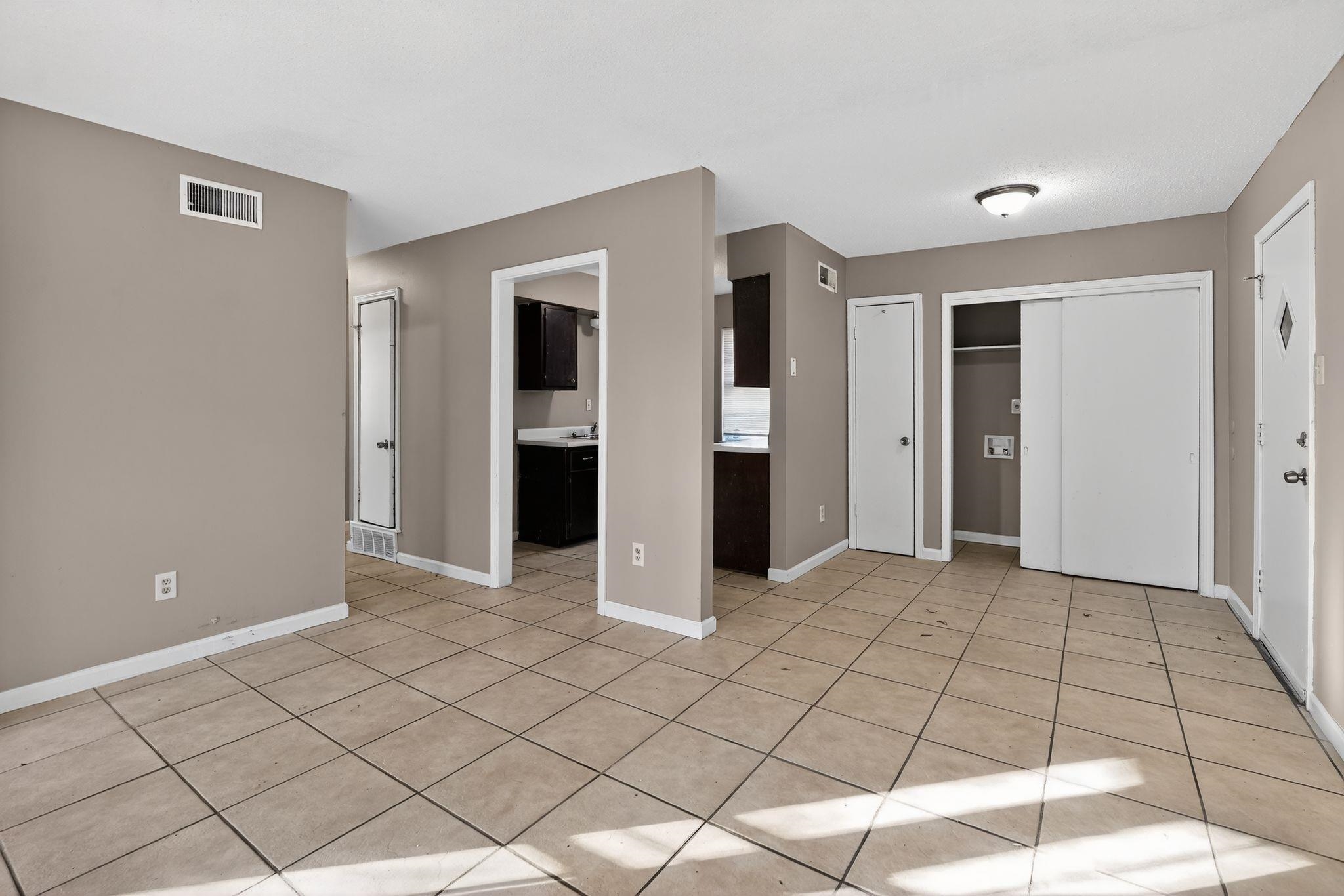 3680 Frayser-Raleigh Road Memphis, TN 38128 - Photo 19 of 40 Unfurnished bedroom with connected bathroom, light tile patterned floors, and multiple closets