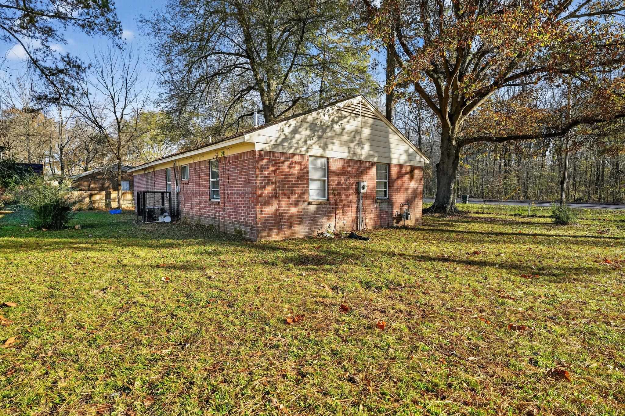 3680 Frayser-Raleigh Road Memphis, TN 38128 - Photo 6 of 40 View of property exterior featuring brick siding and a yard