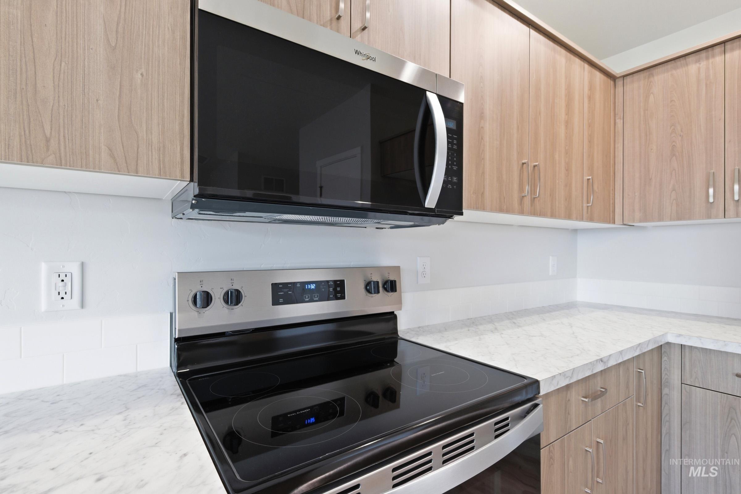 16632 North Shorthorn Loop Nampa, ID 83651 - Photo 8 of 17 Kitchen featuring a stainless steel range with a ceramic cooktop and an over-the-range microwave