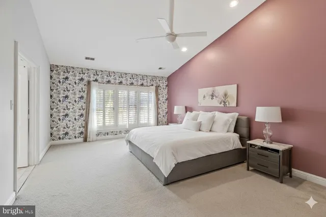 a spacious bedroom with a bed and a window