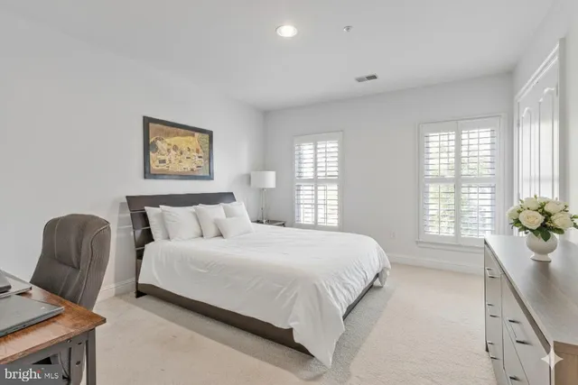 a bedroom with a bed and a chair