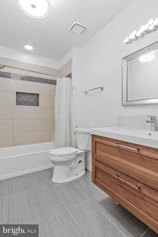 a bathroom with a toilet a sink and bathtub