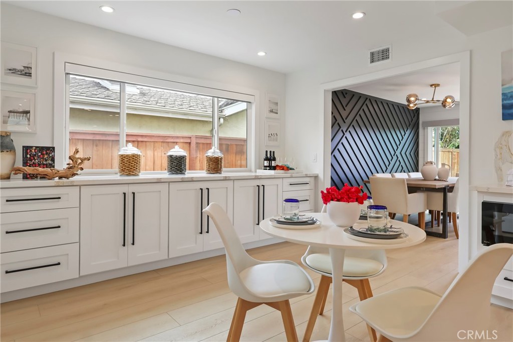 2316 La Linda Place Newport Beach, CA 92660 - Photo 28 of 31 a dining room with furniture a window and wooden floor