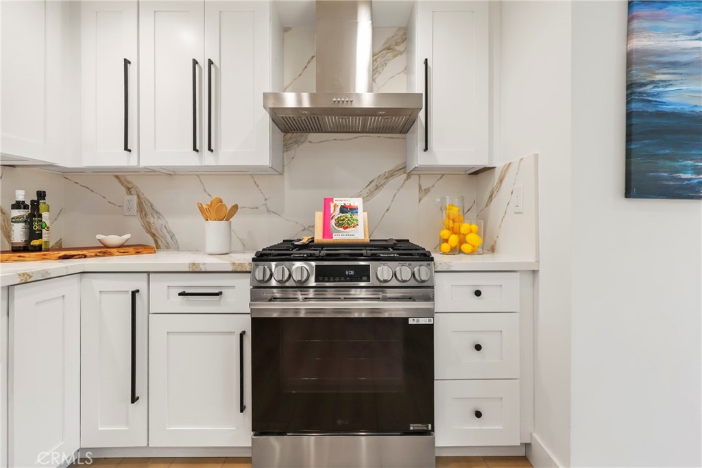 2316 La Linda Place Newport Beach, CA 92660 - Photo 5 of 31 a kitchen with white cabinets and appliances