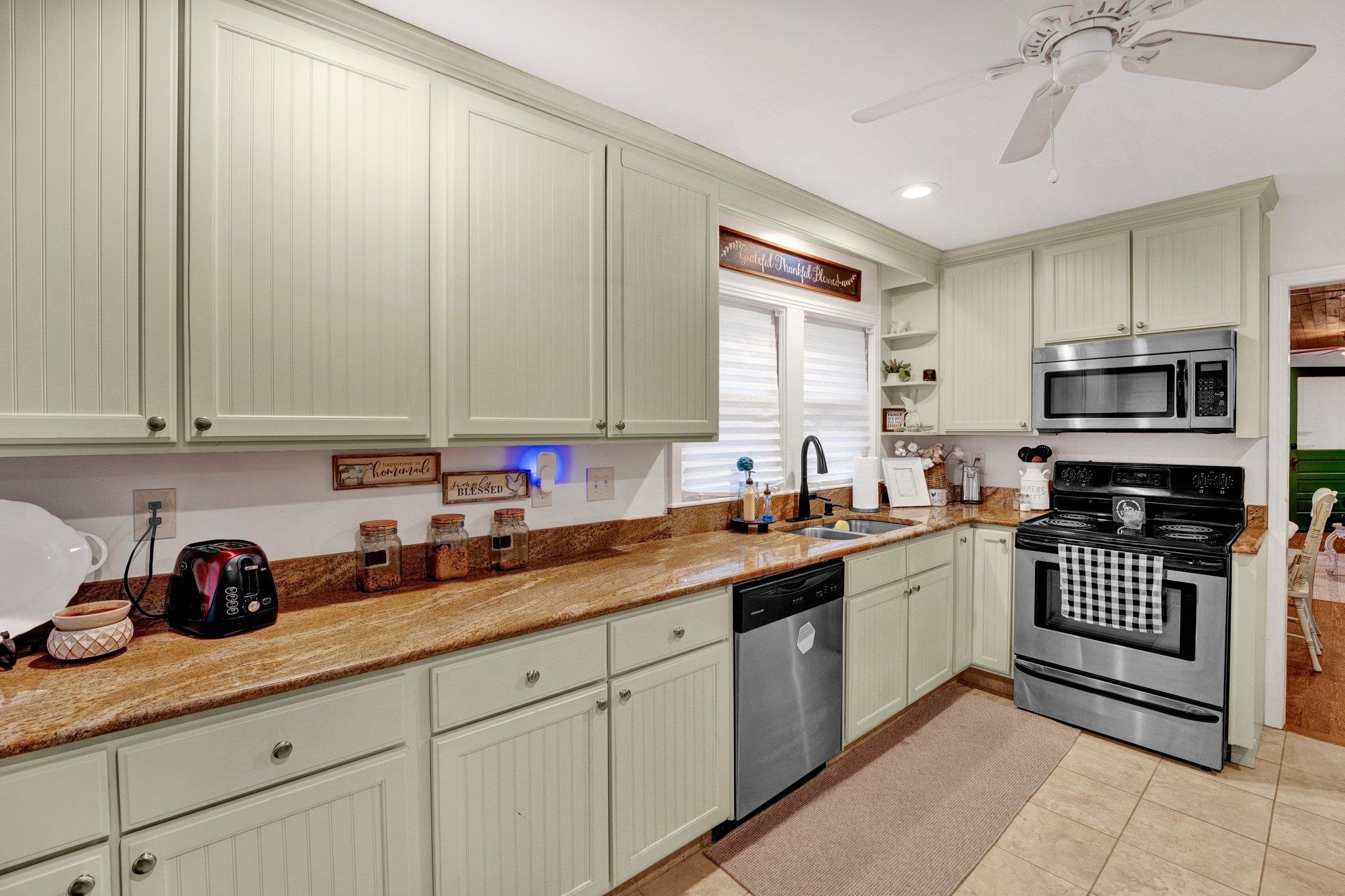 5050 Brunswick Road Bartlett, TN 38002 - Photo 18 of 35 a kitchen with stainless steel appliances granite countertop a sink stove and cabinets