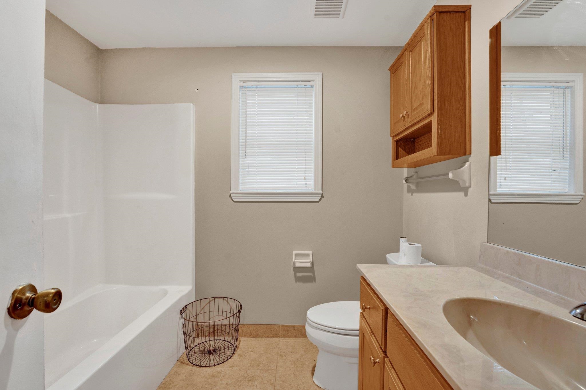 5050 Brunswick Road Bartlett, TN 38002 - Photo 29 of 35 a bathroom with a sink a toilet and shower