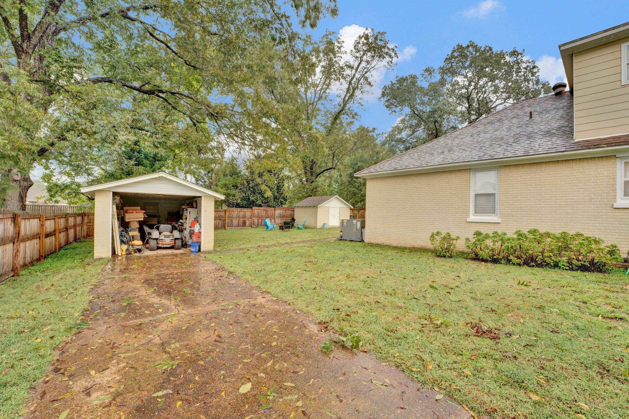 5050 Brunswick Road Bartlett, TN 38002 - Photo 33 of 35 a front view of a house with a garden and trees