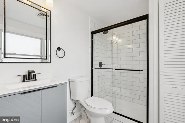 a bathroom with a toilet a sink and a mirror