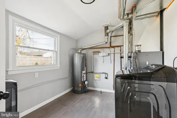 a view of storage and utility room with windows