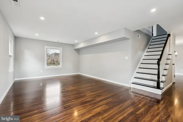 a view of an entryway with wooden floor