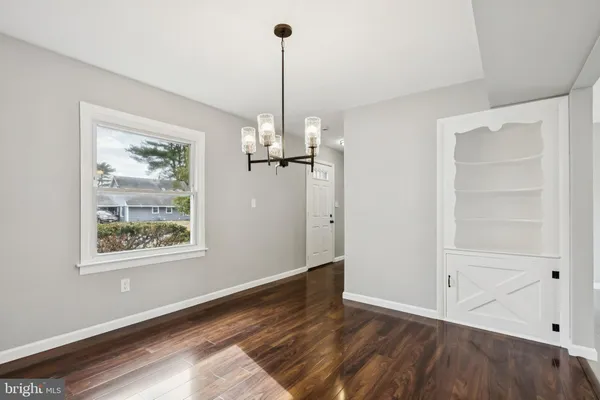 a view of a room with wooden floor closet and windows